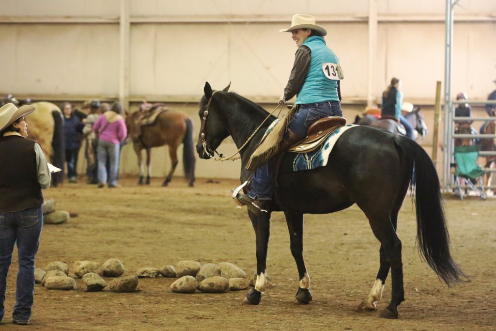 Trainer talking to smiling rider.