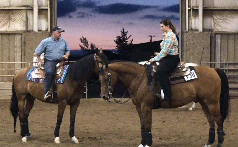 A man and a woman horseback talking.